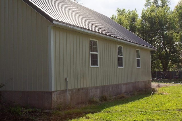 view of home's exterior with a yard and metal roof