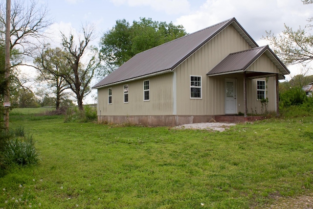 exterior space with a yard and metal roof