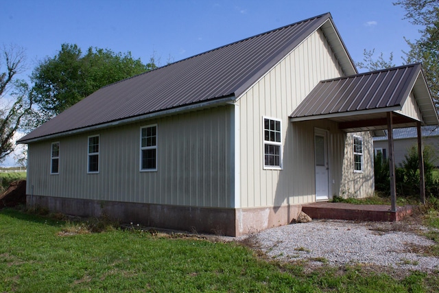view of home's exterior with a lawn and metal roof