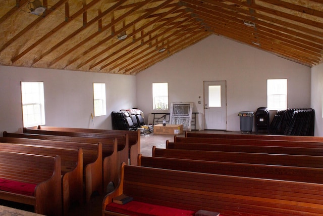 stairway featuring high vaulted ceiling and a healthy amount of sunlight