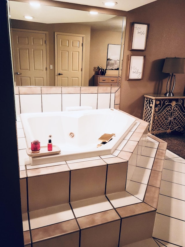 bathroom with recessed lighting, tile patterned floors, and a tub with jets
