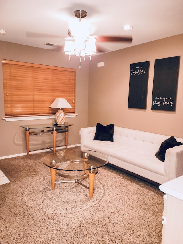 living area featuring baseboards and a ceiling fan