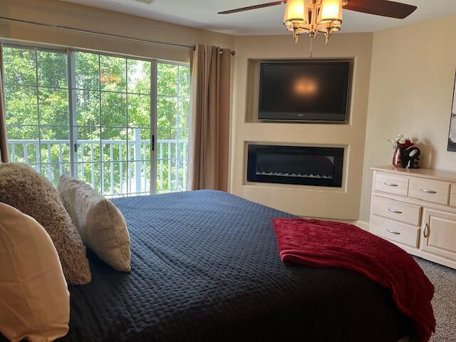 530 Spring Creek Ct Unit 7, Branson, MO 65616 - carpeted bedroom with ceiling fan and access to outside