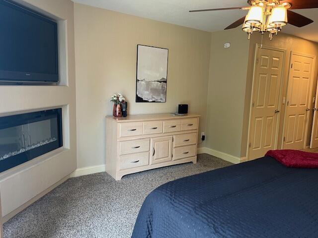 530 Spring Creek Ct Unit 7, Branson, MO 65616 - bedroom featuring dark carpet and a ceiling fan
