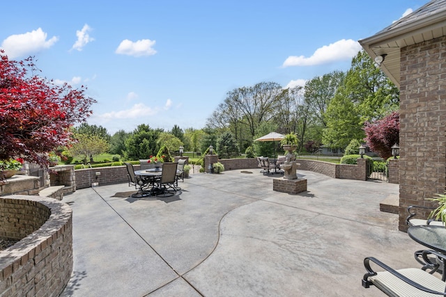 view of patio / terrace with fence, a gate, and outdoor dining area