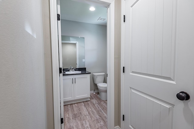 2632 N Prospect Ave, Springfield, MO 65803 - bathroom with toilet, visible vents, wood finished floors, and vanity