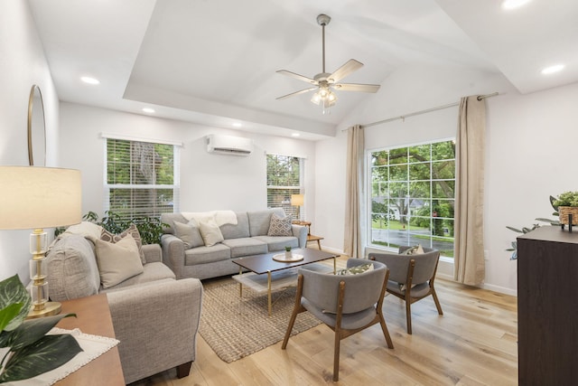 living area with ceiling fan, a wall mounted AC, light wood finished floors, lofted ceiling, and recessed lighting