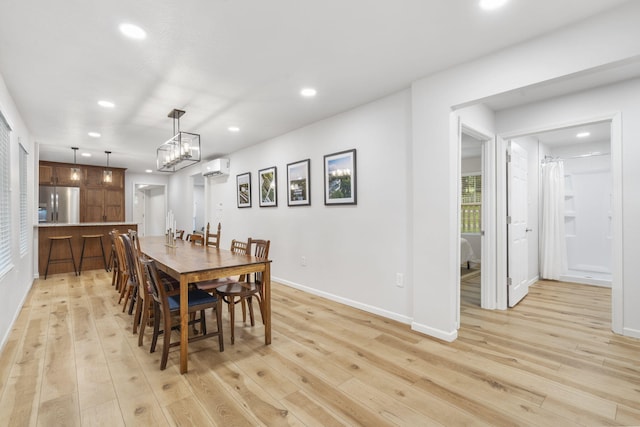 dining space featuring light wood-style floors, recessed lighting, baseboards, and a wall unit AC