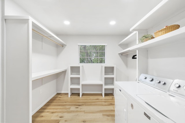 laundry room featuring laundry area, recessed lighting, light wood-style flooring, and washer and clothes dryer