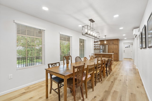 dining room with light wood-type flooring, recessed lighting, baseboards, and a wall mounted AC