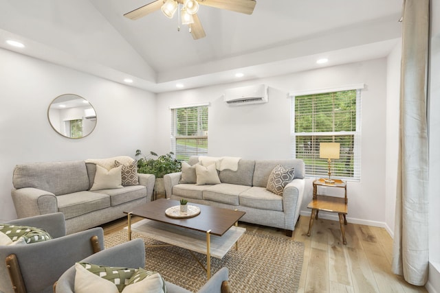 living room featuring recessed lighting, light wood-style flooring, lofted ceiling, and a wall unit AC
