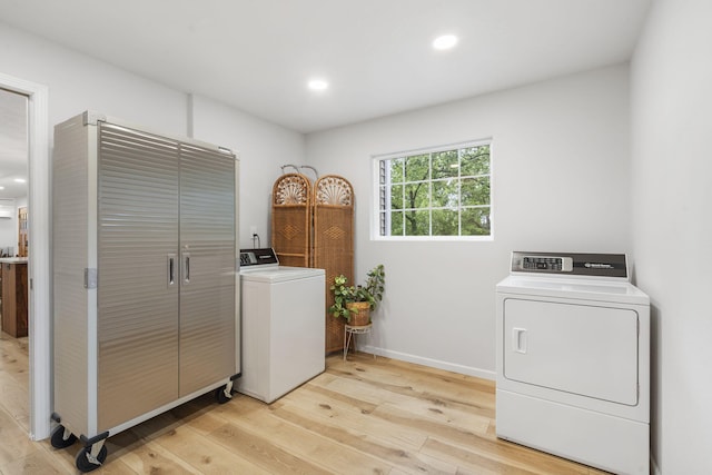 laundry room with laundry area, separate washer and dryer, recessed lighting, baseboards, and light wood-type flooring