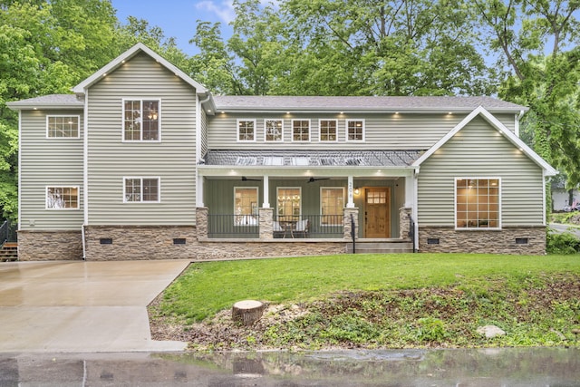 rear view of property featuring covered porch, a shingled roof, a yard, and crawl space