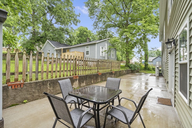 view of patio / terrace with outdoor dining area and fence