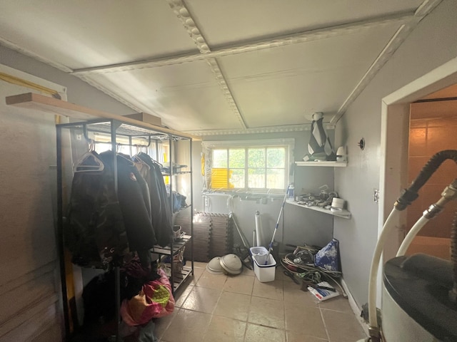interior space with tile patterned floors and lofted ceiling