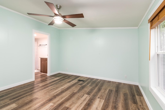 empty room featuring baseboards, a ceiling fan, and dark wood finished floors