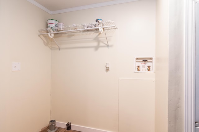 washroom with crown molding, washer hookup, and wood finished floors