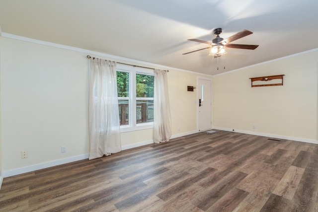 empty room featuring ornamental molding, ceiling fan, and wood finished floors