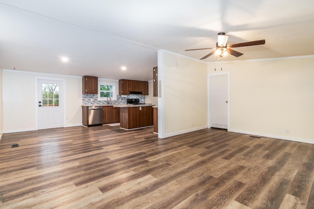 unfurnished living room featuring baseboards, ornamental molding, a ceiling fan, and dark wood-style floors