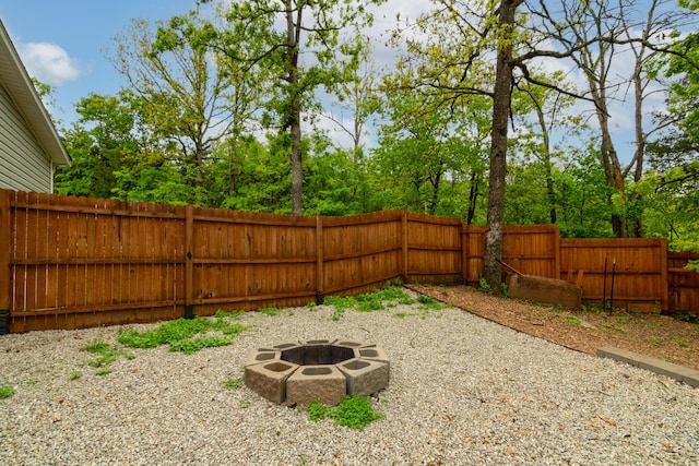 view of yard with a fenced backyard and an outdoor fire pit