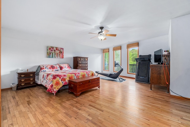 bedroom with baseboards, ceiling fan, and light wood-style flooring
