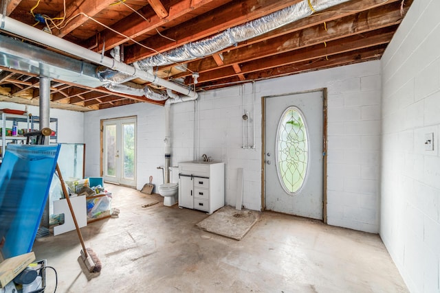 basement with a sink and concrete block wall