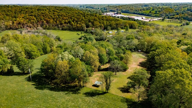 birds eye view of property with a wooded view