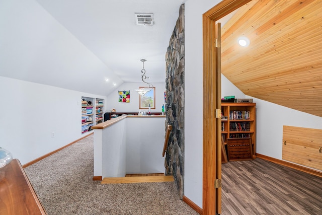 interior space with baseboards, visible vents, an upstairs landing, and lofted ceiling