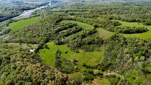 birds eye view of property featuring a wooded view