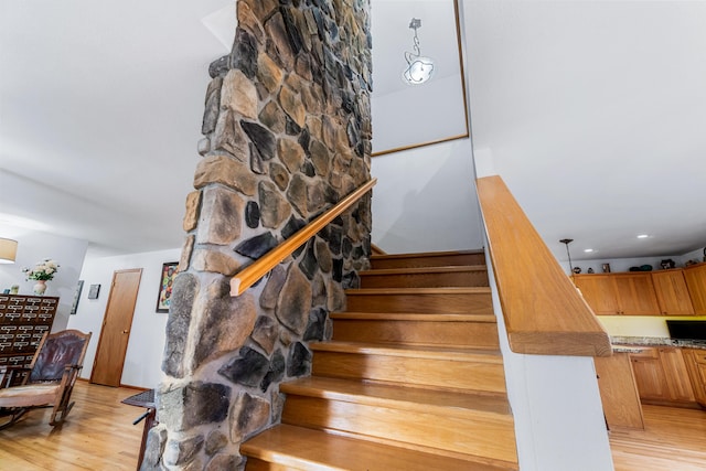 stairway featuring wood finished floors