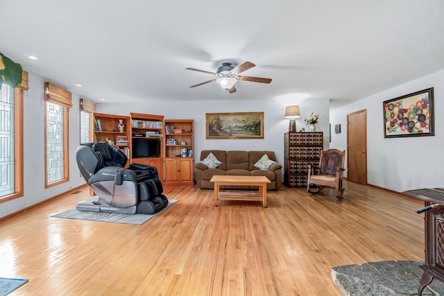 living room with recessed lighting, ceiling fan, baseboards, and light wood-type flooring