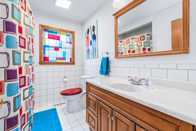 full bath featuring vanity, visible vents, toilet, tile walls, and tile patterned floors