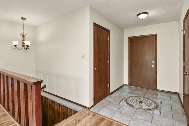entrance foyer featuring an inviting chandelier and baseboards