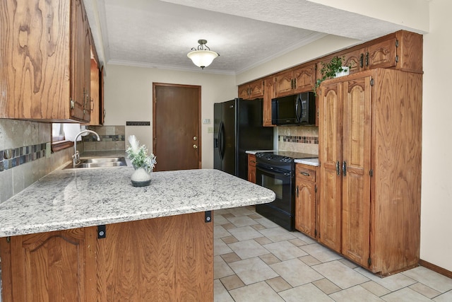 kitchen with a sink, light countertops, a peninsula, decorative backsplash, and black appliances