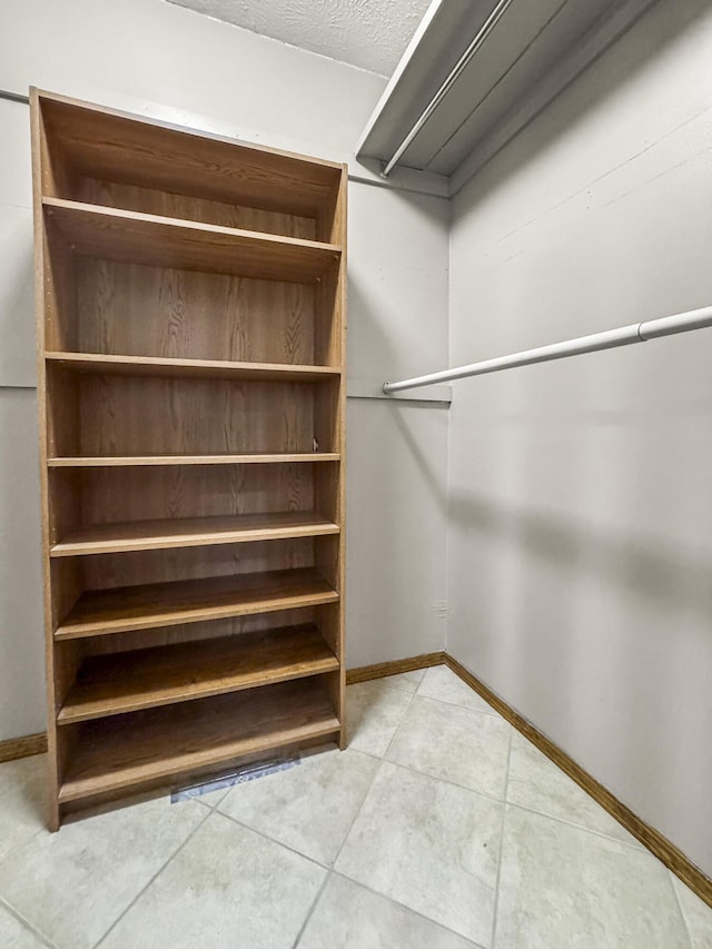 walk in closet featuring light tile patterned floors