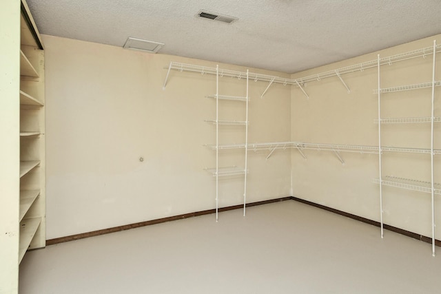 spacious closet featuring visible vents