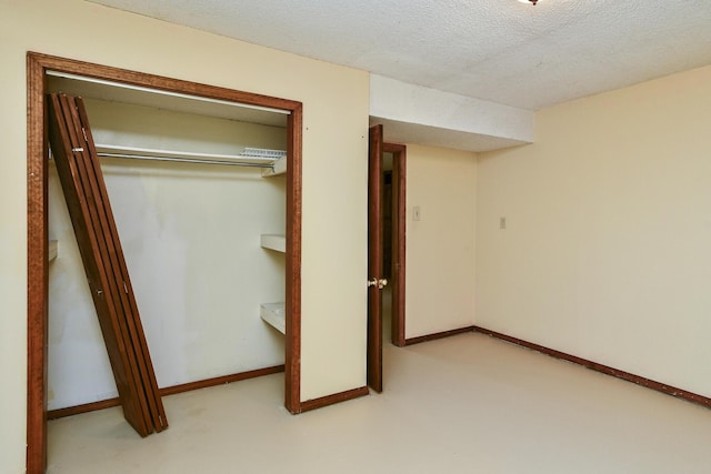 interior space featuring a closet, a textured ceiling, and carpet floors