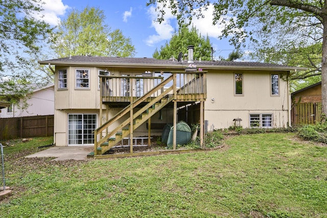 back of property featuring stairs, fence, a yard, and a deck