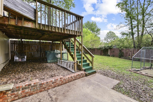 view of yard with a deck, stairs, a fenced backyard, and a patio area