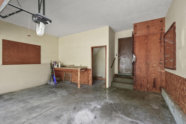 garage featuring a garage door opener and a workshop area