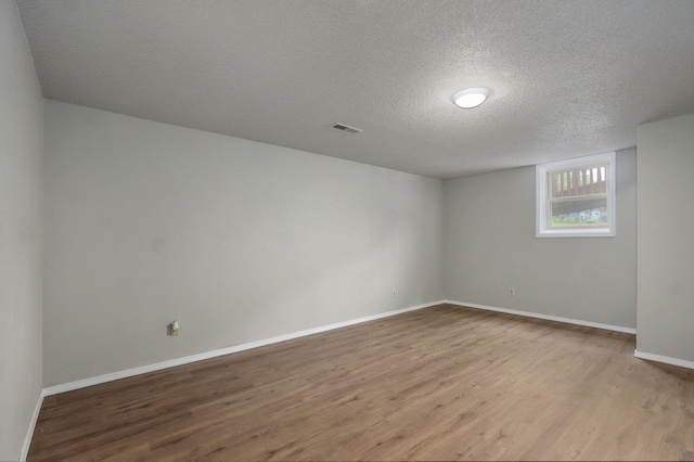 523 E Camino St, Springfield, MO 65810 - empty room featuring baseboards, a textured ceiling, wood finished floors, and visible vents