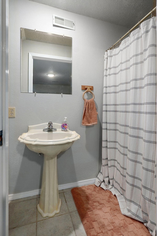 523 E Camino St, Springfield, MO 65810 - bathroom with visible vents, baseboards, a textured ceiling, tile patterned floors, and a shower with curtain