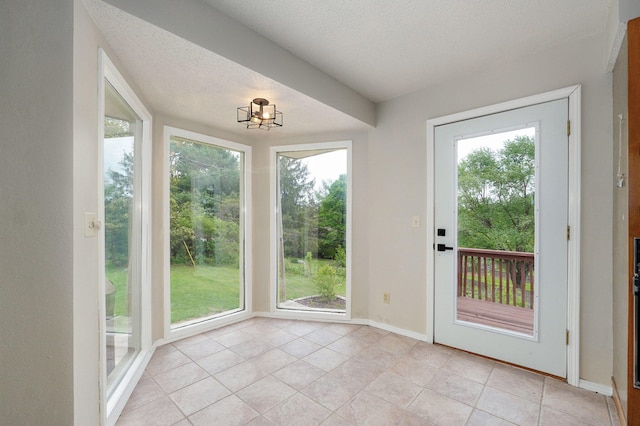 523 E Camino St, Springfield, MO 65810 - doorway featuring baseboards, a textured ceiling, a chandelier, and light tile patterned flooring