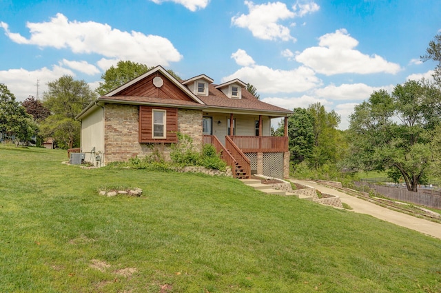 523 E Camino St, Springfield, MO 65810 - view of front of house featuring central air condition unit, stairs, covered porch, and a front yard