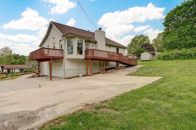 523 E Camino St, Springfield, MO 65810 - back of property with a garage, a wooden deck, a yard, a chimney, and driveway