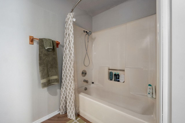 523 E Camino St, Springfield, MO 65810 - bathroom with shower / bath combo with shower curtain, baseboards, and wood finished floors