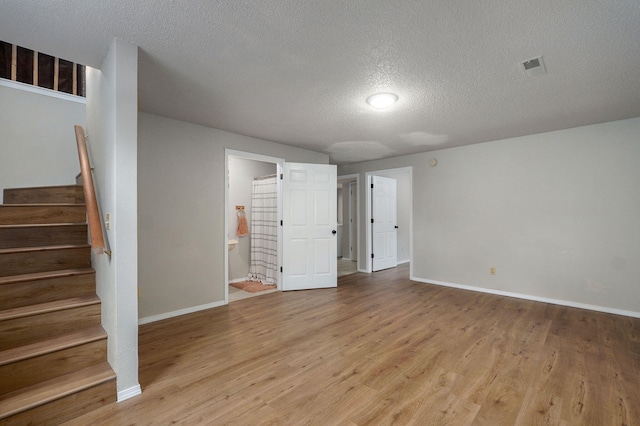 523 E Camino St, Springfield, MO 65810 - interior space featuring stairway, a textured ceiling, baseboards, and light wood finished floors