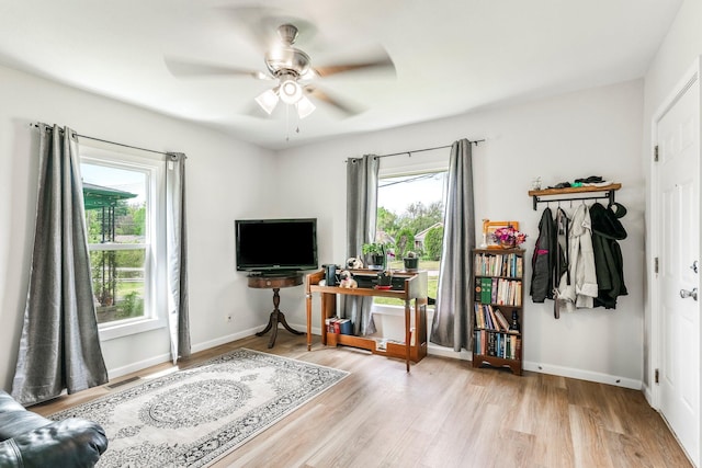 interior space featuring baseboards, ceiling fan, and wood finished floors