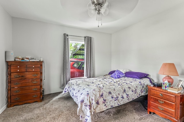 bedroom with a ceiling fan and carpet