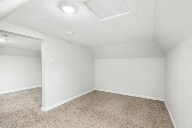bonus room featuring baseboards, carpet, and lofted ceiling